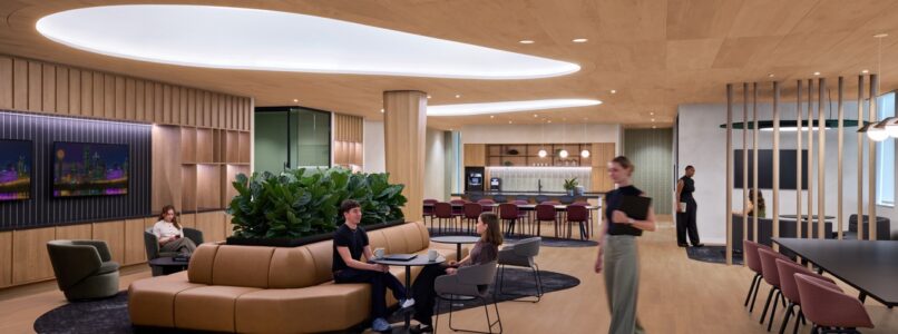 Social hub with curved sofa, cafe seating and oval ceiling cove in the Rocket office