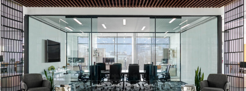 Glass-walled conference room framed by wood-slat ceiling and bookshelves at 2525 Knight Street