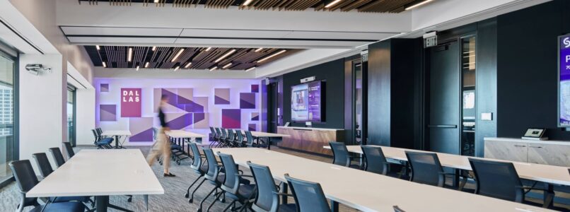 Multipurpose room with long tables, navy chairs and wood-slat ceiling in the Accenture Dallas office