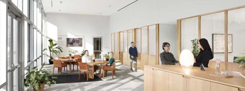 Reception desk with wood paneling and lounge beyond in the Fidelity office