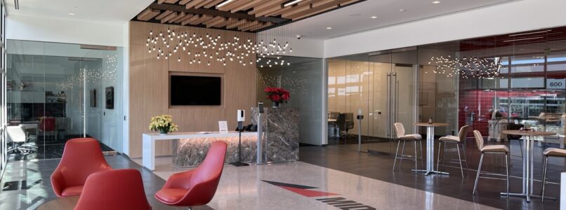 Reception area with red swivel chairs and a wood-slat ceiling in a foodservice equipment showroom