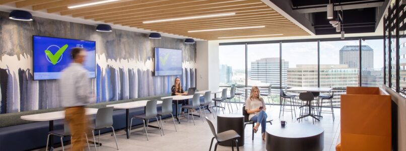 Cafe and lounge with orange chairs under a wood-slat ceiling in the Lehigh Hanson office