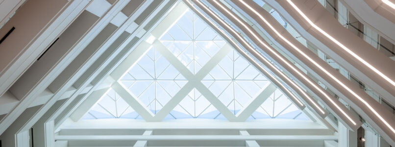 Atrium skylight with white triangular structural framing in the Oncor office