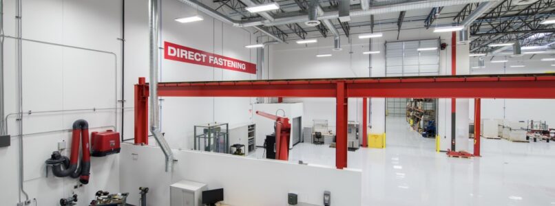 Tool testing area with red overhead framing and workbenches at the Hilti Parc Royal facility