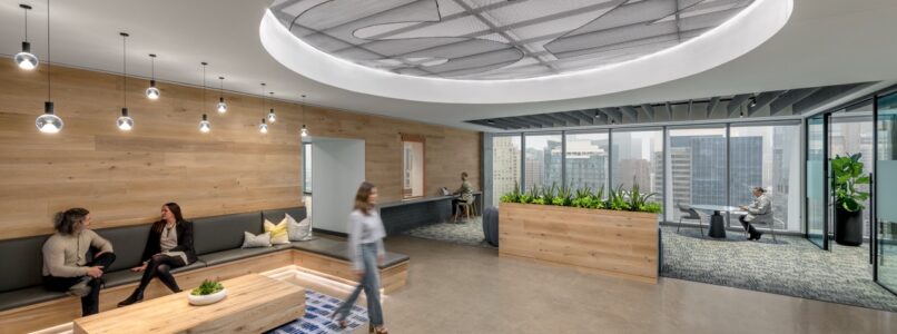 Lounge with wood-clad walls, a circular ceiling feature and window views in the S2 Capital office