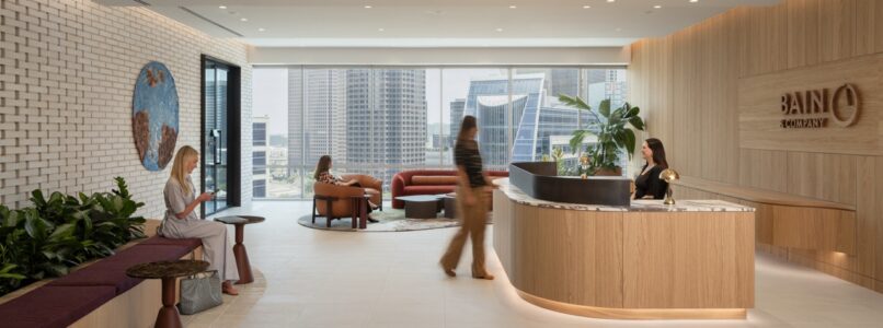 Reception desk with Bain logo, planter bench and skyline views