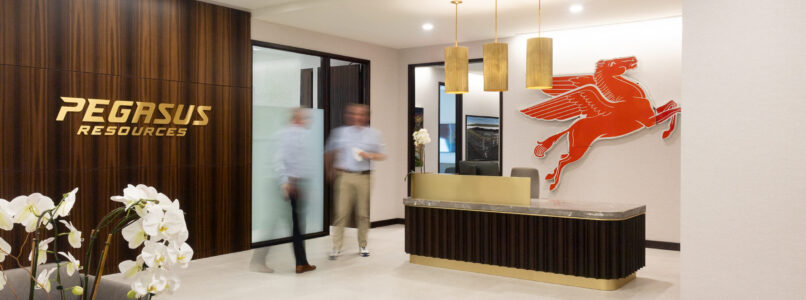 Pegasus Resources reception with wood logo wall and red Pegasus sculpture